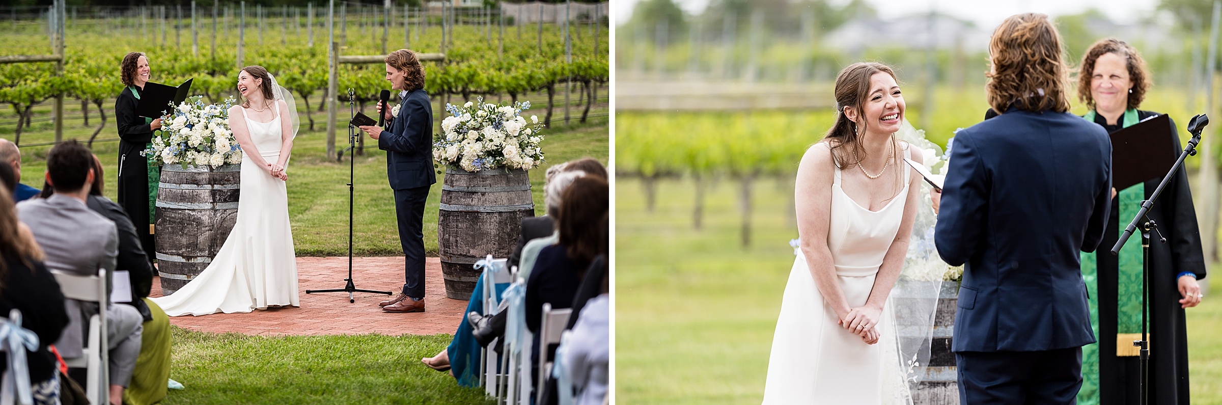 A wedding couple stands at an outdoor ceremony in a vineyard. The bride is in a white dress, and the groom in a navy suit. An officiant stands beside them. White flowers decorate wooden barrels nearby.